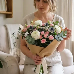 Woman holding a fresh bouquet of pink and white flowers