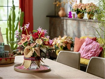 Full colorful floral arrangement on a dining table — a statement arrangement with strong presence
