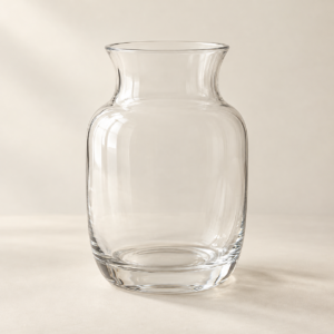 Empty clear glass vase with rounded sides and a narrow neck